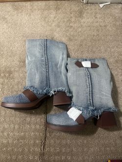 light wash denim fold over boots with distressed frayed hems and buckled strap detail