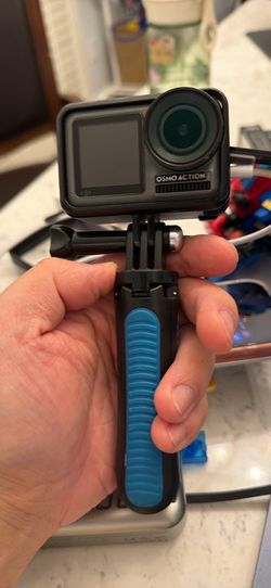 DJI Osmo Action Camera with Floating Handle and a rechargeable battery