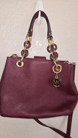 Burgundy Michael Kors purse with gold accents
