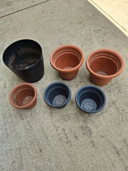 Six plastic planters