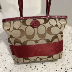 Coach signature stripe tote bag in tan canvas with red leather trim and matching apple charm