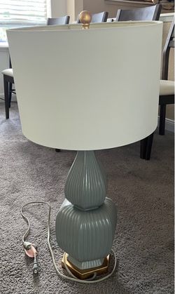 contemporary ribbed/fluted double-gourd style ceramic table lamp with a brushed gold hex base and matching finial.