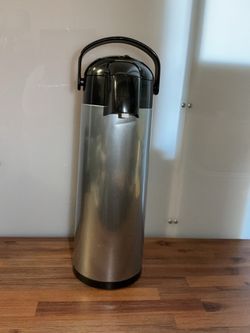 This "airpot"-style beverage dispenser features a stainless steel exterior finish and a top-mounted pump system.