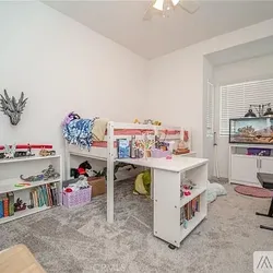 Low twin loft bed with pullout desk, dresser, and shelves.