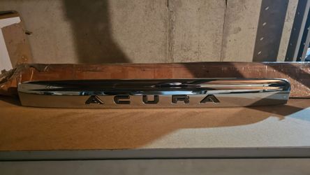Front grille emblem displaying the Acura logo
