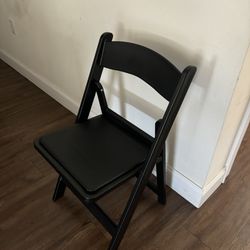Foldable black wooden chair with small seat pad 