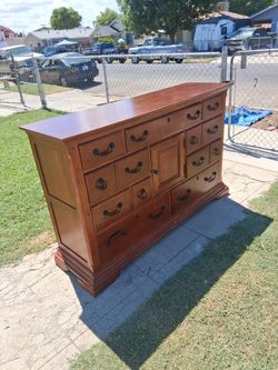 A nine drawer one cabinet dresser