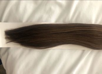 New NEVER worn -soft and natural looking Remy human hair 22” ponytail. Color is med-dark brown with soft caramel brownish colored highlights. Paid $98