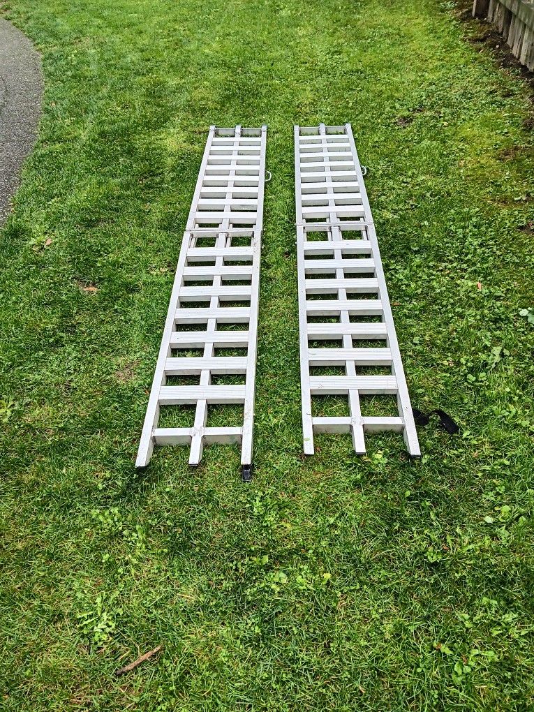 7.1/2 foot long folding aluminum ramps 12 ins wide used 1 time good for dirt bikes and riding mowers and golf carts work great