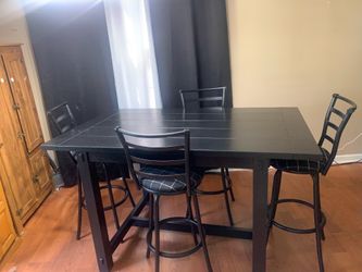 Kitchen table with four swivel stools. Black, rectangular & counter height.
