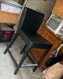 Black faux leather barstool