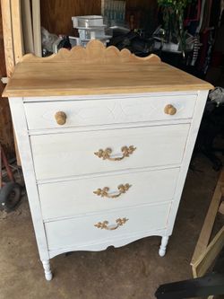 Elegant vintage dresser with ornate handles and a wooden top