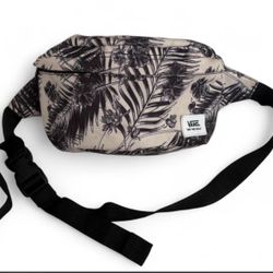 Vans "Off The Wall" branded fanny pack features a black and white tropical floral pattern and an adjustable strap for  styling around the waist