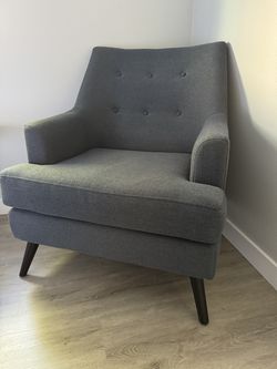 Two medium-sized dark navy fabric armchairs with black painted legs