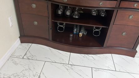 Entertainment stand with wine glasses and wine bottle holder and 6 drawers