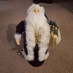 Santa wearing a Purple Robe & holding bells