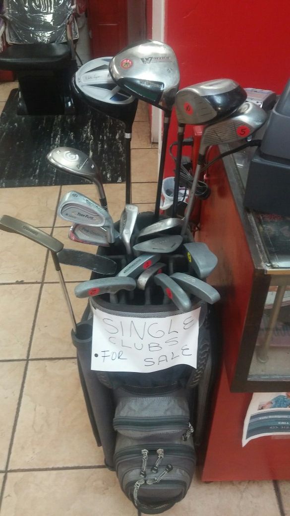 Assorted used golf clubs