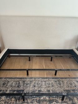 Beige upholstered bed and box spring