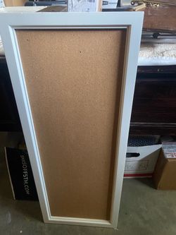 A Large White Framed Cork Board