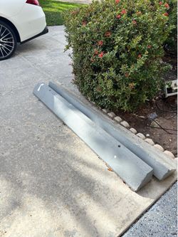 2 concrete parking blocks Please bring help with you.