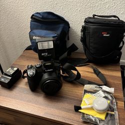 LUMIX FZ-300 Camera W Battery, Charger, 2 Bags, Flash Add On, Lens Cleaning Tools And Items