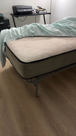 Twin size mattress and a metal frame