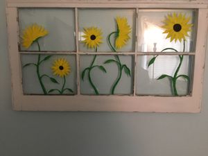 Photo Old wood window with sunflowers painted on it