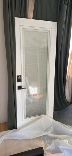 White door with black handle and lock system