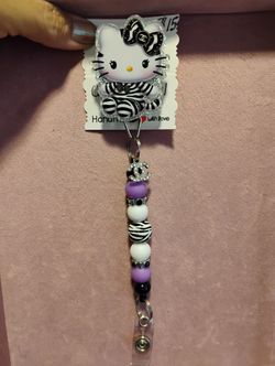 purple and black hello Kitty badge reel