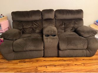 Electric reclining two seater sofa with a center console