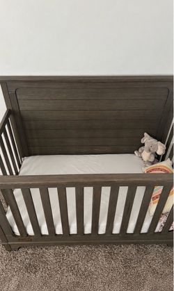 Dark Wood Baby Crib with Mattress  Beautiful dark espresso wood baby crib with mattress included! Features a classic design, sturdy construction
