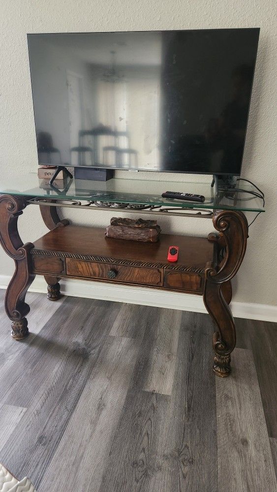 Wooden console table with glass top 