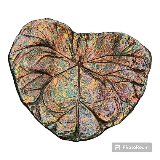 Hand-made leaf pottery.I'm not quite sure what it is made of , it's very heavy , and it looks to be hand painted. Very pretty, 12x12