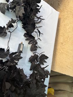 Black leaf garland with orange lights for Halloween or dia de Los muertos decor