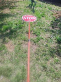 Flagger hand held stop. Slow sign