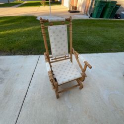 Vintage wooden platform rocking chair with turned spindles & light-colored floral upholstered pads