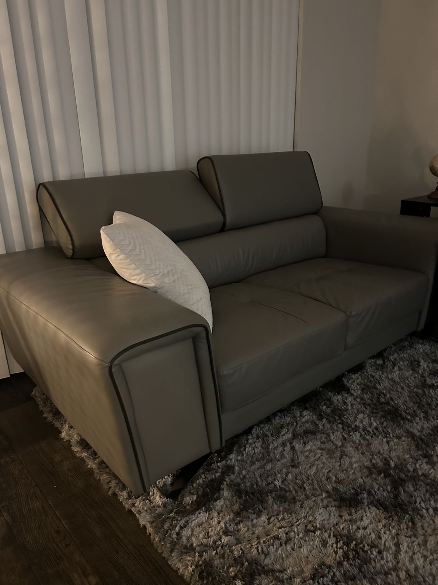 Modern Gray Leather Couch with Adjustable Headrests and Metal Legs