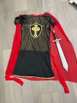 Medieval knight costume tunic with a red cape and a toy sword