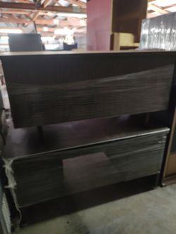 Lightly Use Desks And Other Office Equipment Wrapped And Stored In A Warehouse