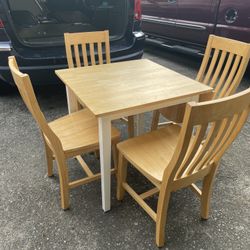Nice solid wood dining table with 4 chairs in condition and it is made in THAILAND .. 