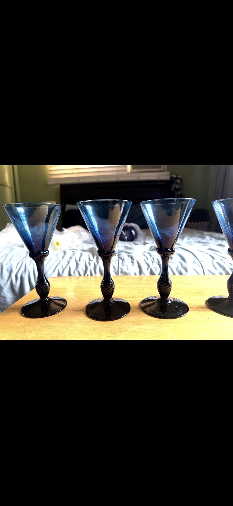 blue wine glasses in the image appear to be antique, possibly Georgian-e