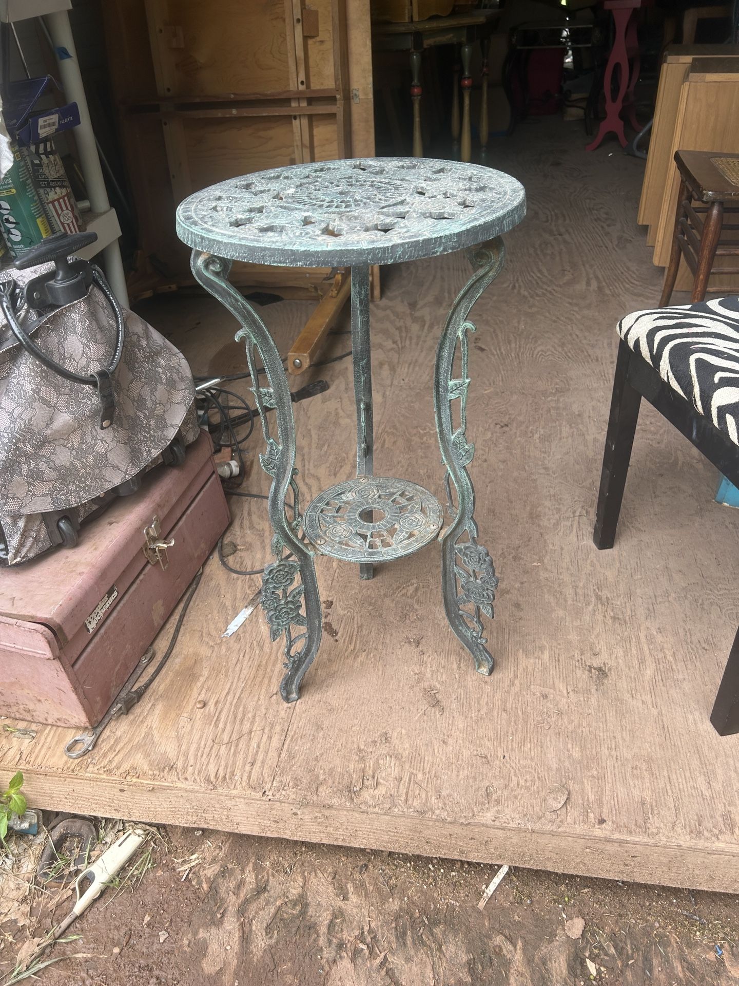 old cast iron plant stand its 28 inches tall and 15 inches across the top