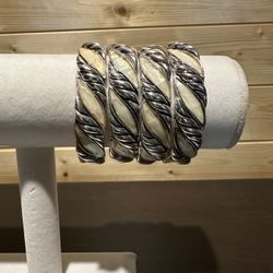 Four stackable ivory and silver stretch bracelets. 