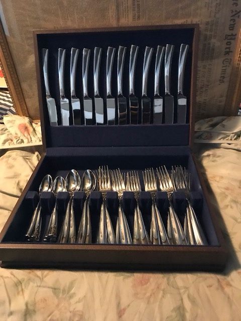 Mint condition 60 pieces JEAN COUZON. SILHOUETTE BRIGHT SERVICE FOR 12 flatware with all wood case. THE COUZON NAME IS ENGRAVE AT THE BOTTOM OF EACH