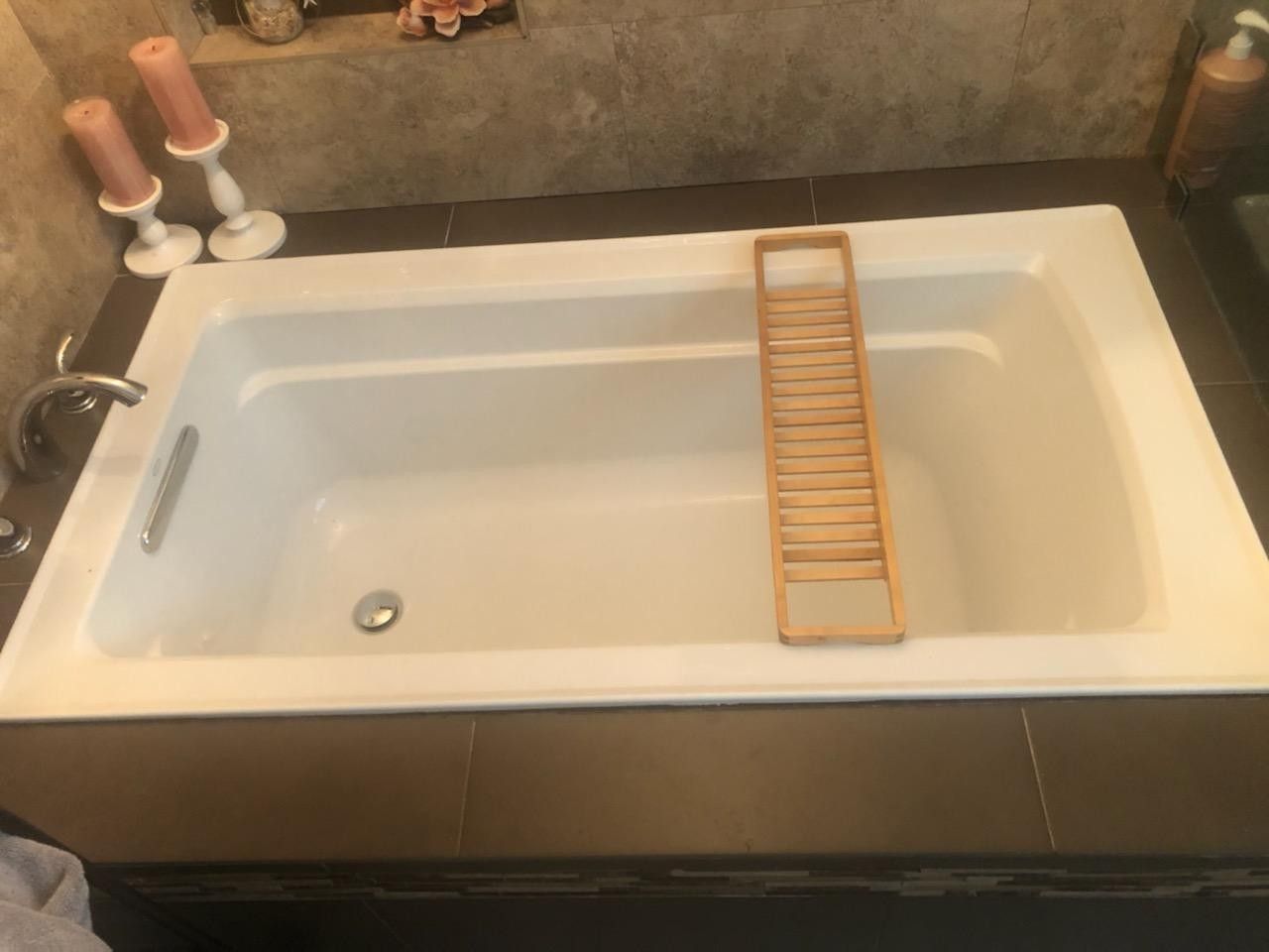 High end Kohler bathtub with faucet and wood frame