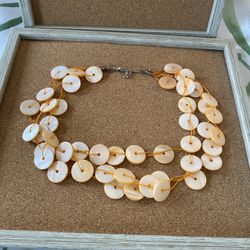 Tropical orange cream button necklace makes sounds.   