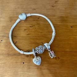 Pandora sterling silver bracelet with three charms size 7.5”