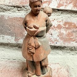 Vintage  wooden sculpture of a woman in traditional attire