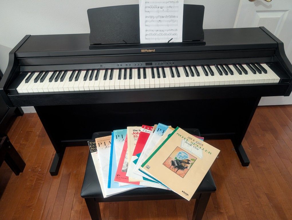 Roland RP 500-CB 88 key digital piano, bench and music books