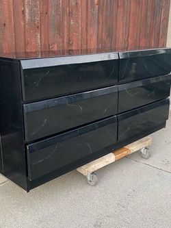 Black dresser with marble look finish